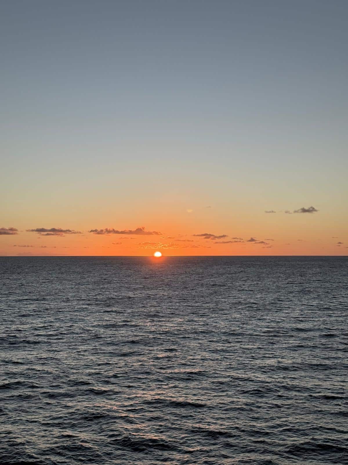 Sunset over calm ocean waters on the way to Hawaii
